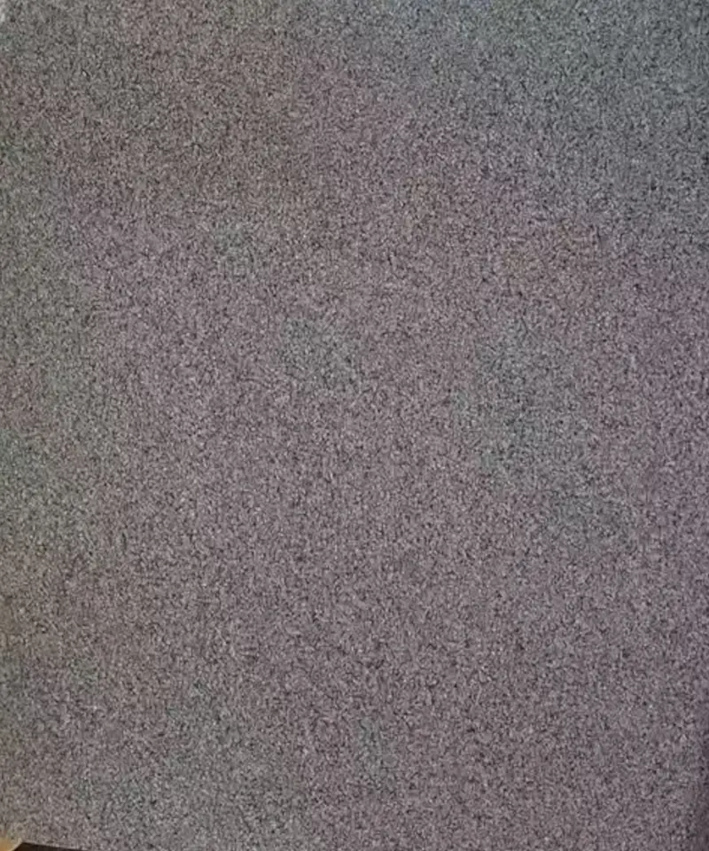 close-up of polished G654 grey granite slab with consistent fine grain texture