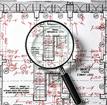 Magnifying glass examining a hand-drawning on-site measurement sketch, detailing dimensions for stone installation.
