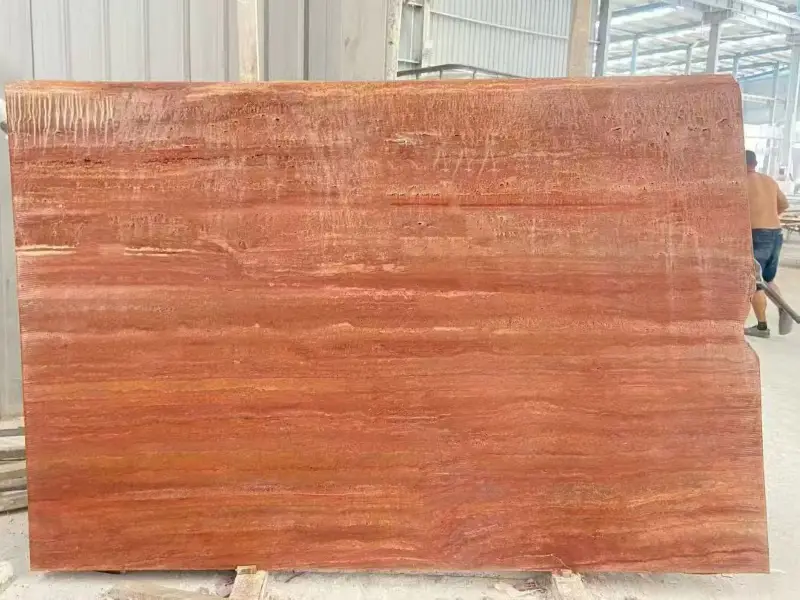 Honed unfilled Red Travertine with open pores and linear veins