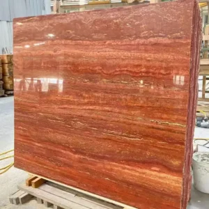 Stack of vein-cut Red Travertine slabs with natural variation